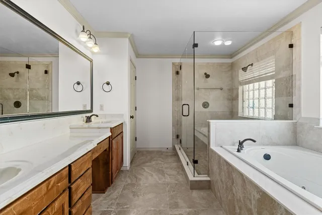 a bathroom with a tub a sink a mirror a shower and vanity