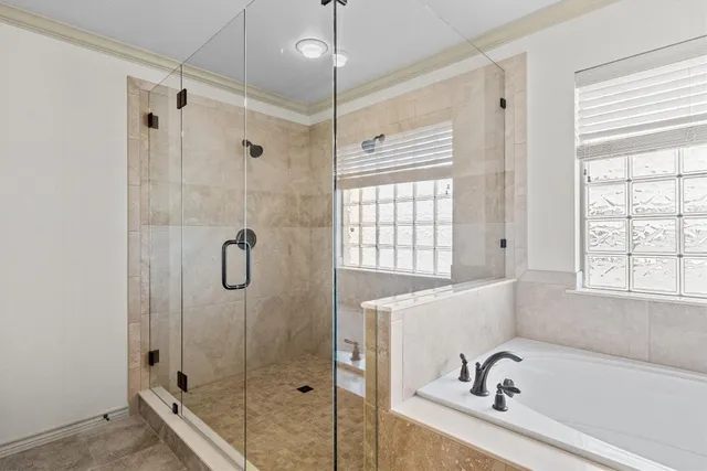 a bathroom with a tub a sink and a window