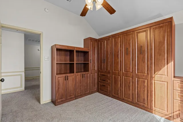 a view of an empty room with a ceiling fan