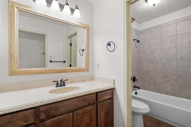 a bathroom with a sink a toilet a shower and a mirror