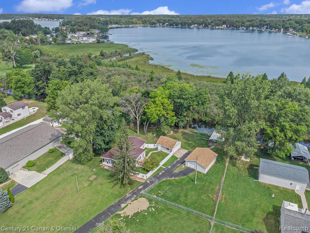 10228 Rexford Road Grass Lake, MI 49240 - Photo 2 of 24 Aerial view of property and surrounding area with a nearby body of water and nearby suburban area