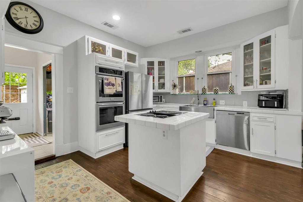 307 North Edgefield Avenue Dallas, TX 75208 - Photo 12 of 28 a kitchen with a stove and a sink
