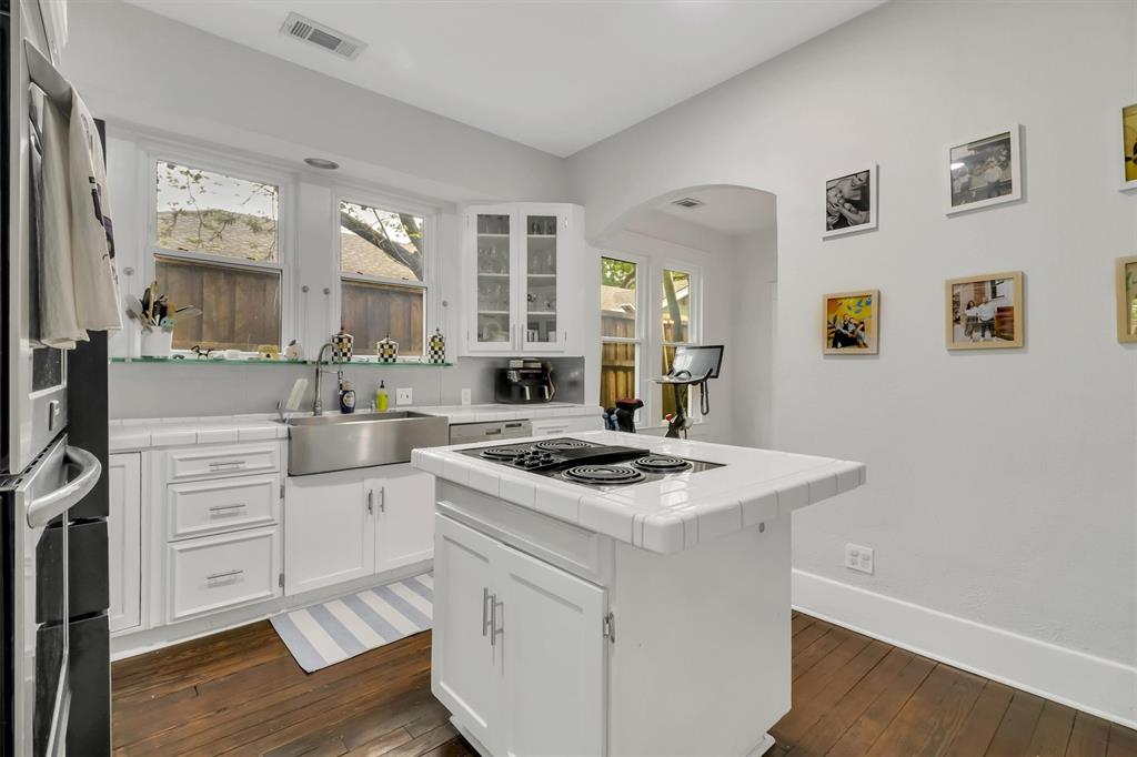 307 North Edgefield Avenue Dallas, TX 75208 - Photo 13 of 28 a kitchen with a stove cabinets and wooden floor