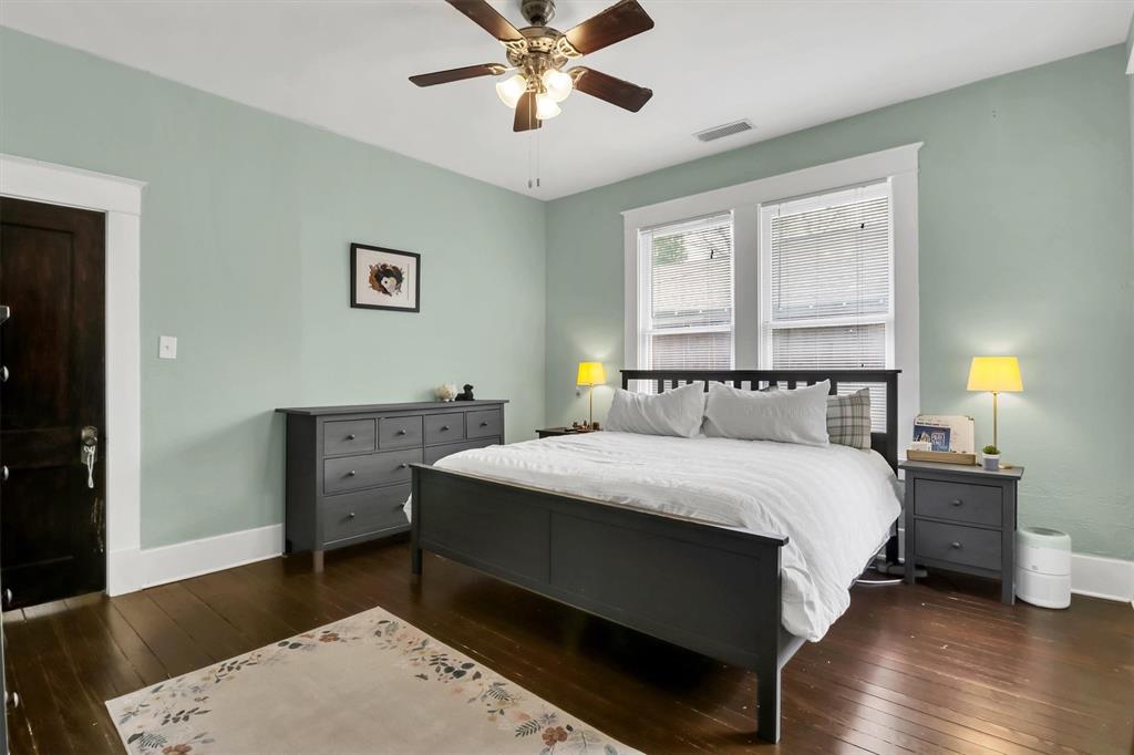 307 North Edgefield Avenue Dallas, TX 75208 - Photo 20 of 28 a bedroom with a bed and wooden floor