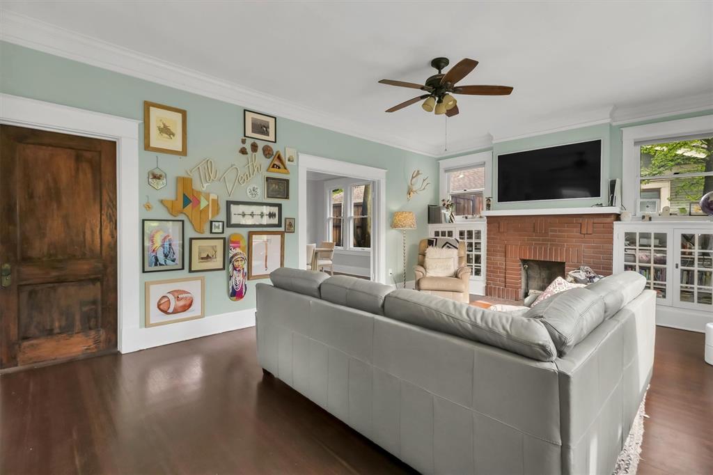 307 North Edgefield Avenue Dallas, TX 75208 - Photo 3 of 28 a living room with furniture a flat screen tv and a fireplace