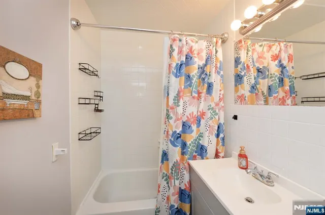 a bathroom with a sink and a shower curtain