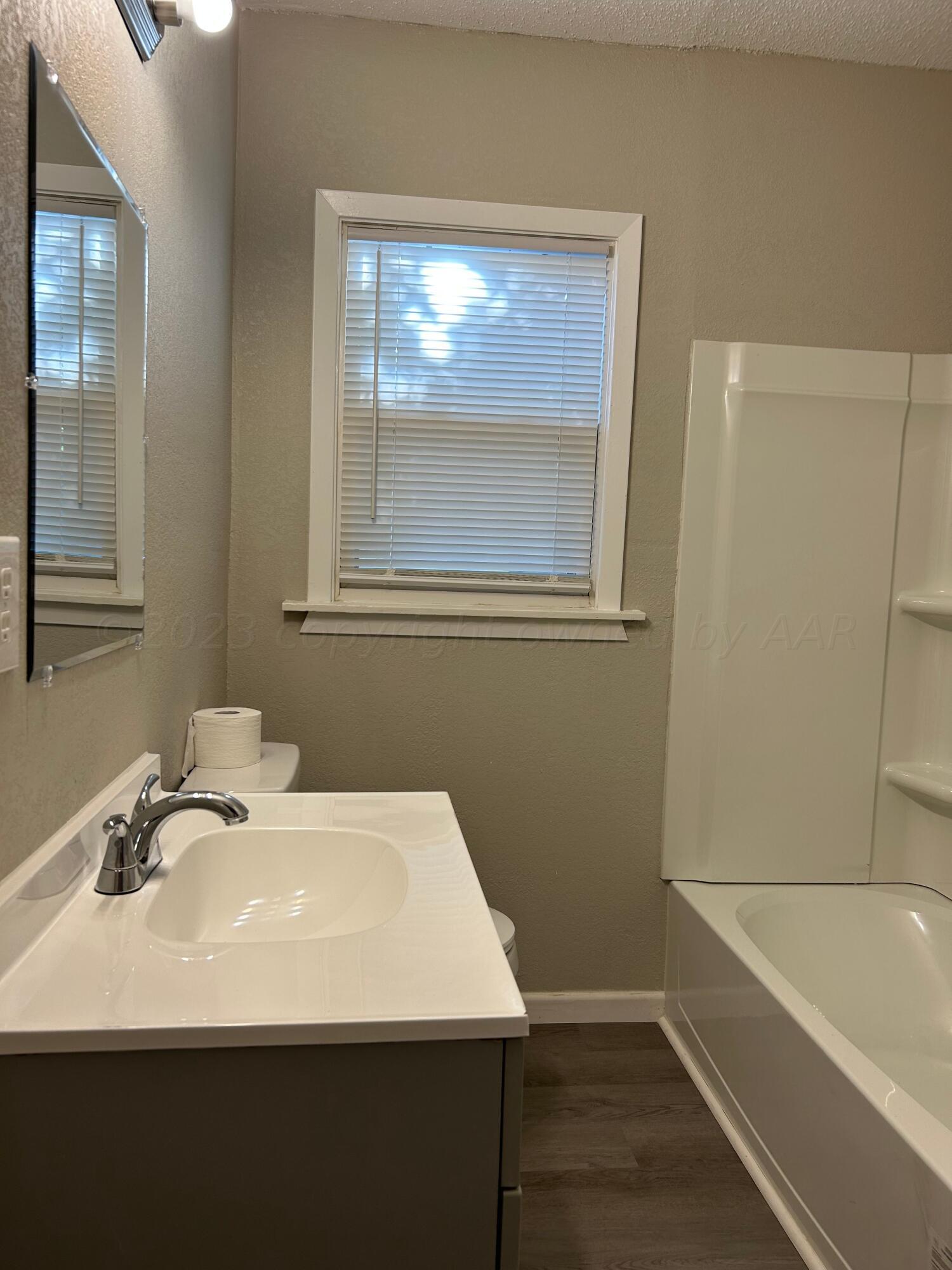 1408 Southwest 12th Avenue Amarillo, TX 79102 - Photo 15 of 25 a bathroom with a sink and a bathtub