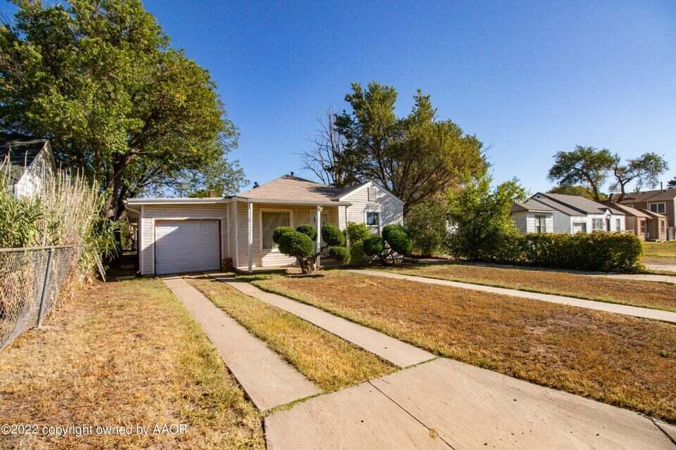 1408 Southwest 12th Avenue Amarillo, TX 79102 - Photo 2 of 25 a house with yard and trees in the background