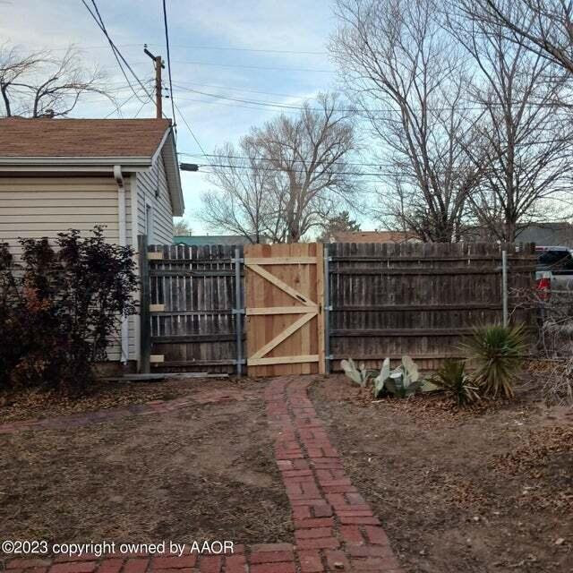 1408 Southwest 12th Avenue Amarillo, TX 79102 - Photo 25 of 25 a view of backyard with wooden fence and a large tree