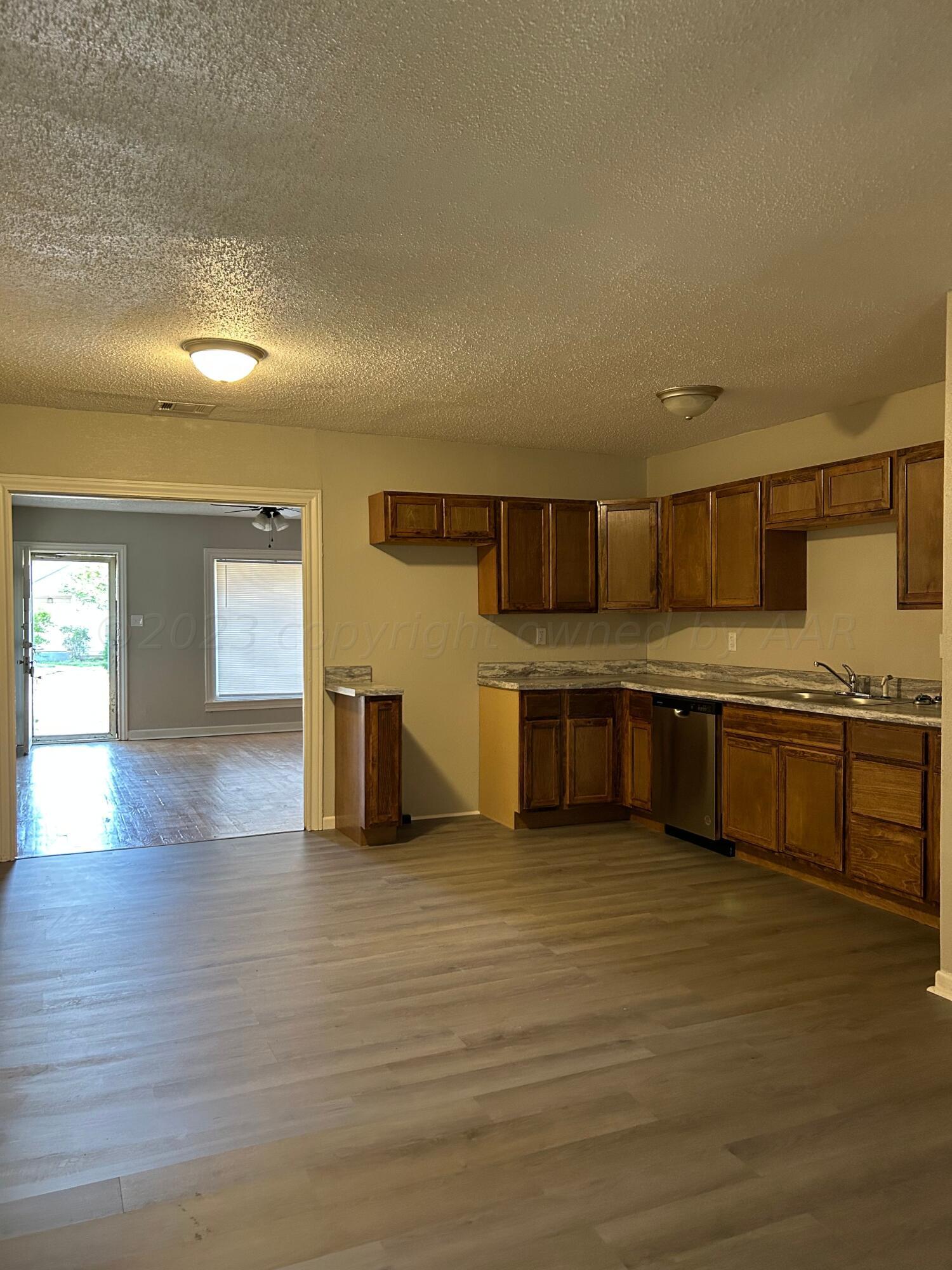 1408 Southwest 12th Avenue Amarillo, TX 79102 - Photo 6 of 25 a kitchen with stainless steel appliances a sink a stove top oven a counter space and cabinets