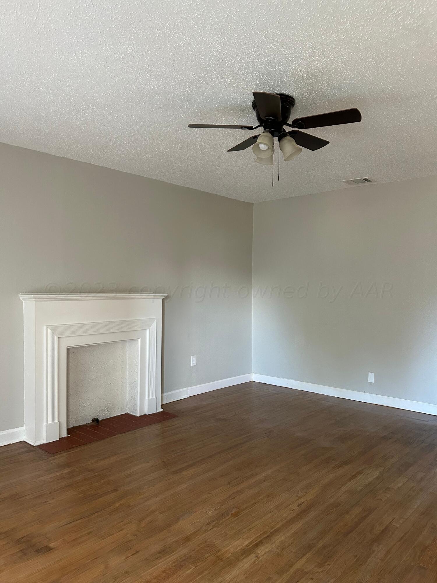 1408 Southwest 12th Avenue Amarillo, TX 79102 - Photo 8 of 25 a view of a room with wooden floor and a ceiling fan