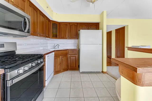 a kitchen with a stove a refrigerator and a sink