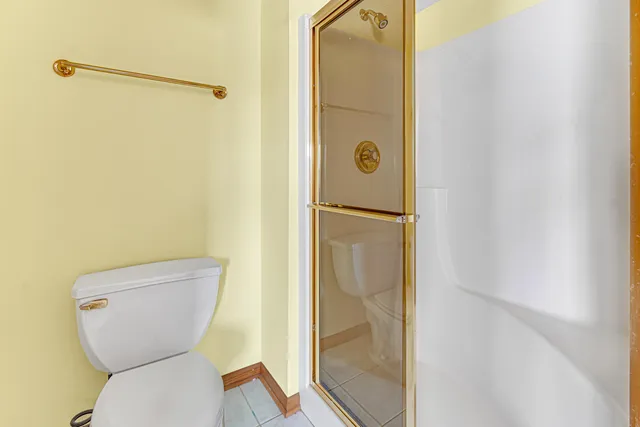 a bathroom with a toilet and a shower