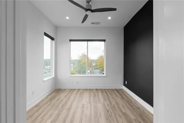 wooden floor in an empty room with a window