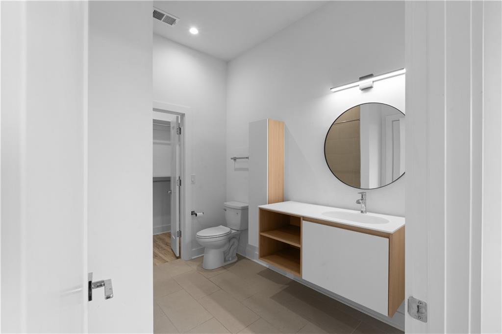 1155 Custer Avenue Southeast, Unit 301 Atlanta, GA 30316 - Photo 19 of 22 a bathroom with a toilet sink and mirror