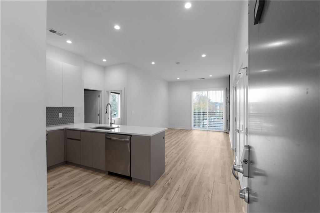 1155 Custer Avenue Southeast, Unit 301 Atlanta, GA 30316 - Photo 2 of 22 a kitchen with stainless steel appliances a sink and wooden floor