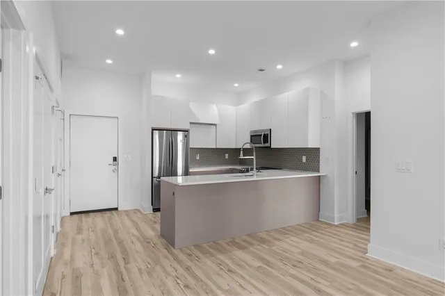 a view of a storage and utility room with washer and dryer