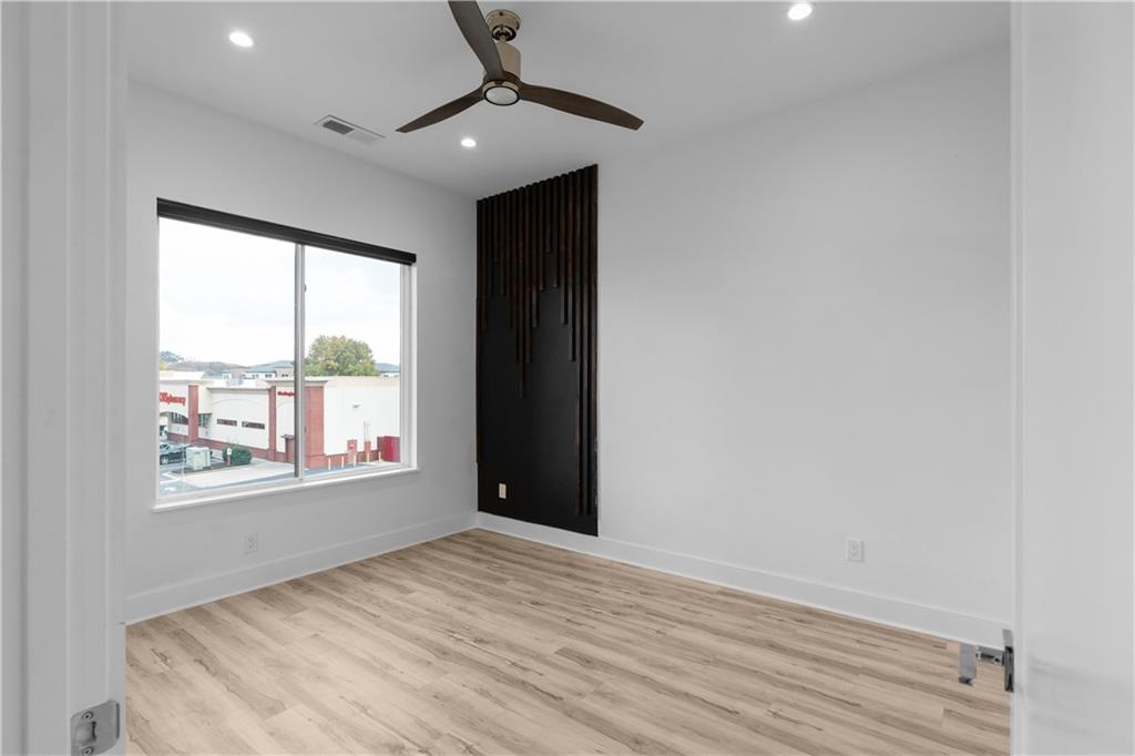 1155 Custer Avenue Southeast, Unit 301 Atlanta, GA 30316 - Photo 9 of 22 wooden floor in an empty room with a window