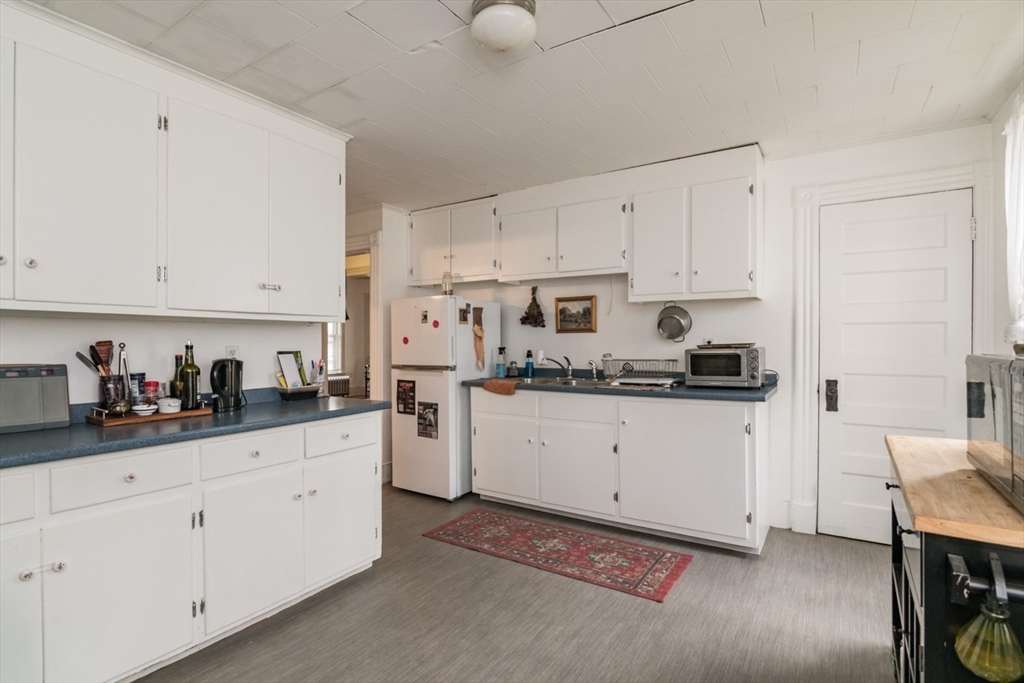 25 Morgan Street Holyoke, MA 01040 - Photo 11 of 41 a kitchen with cabinets stainless steel appliances and sink