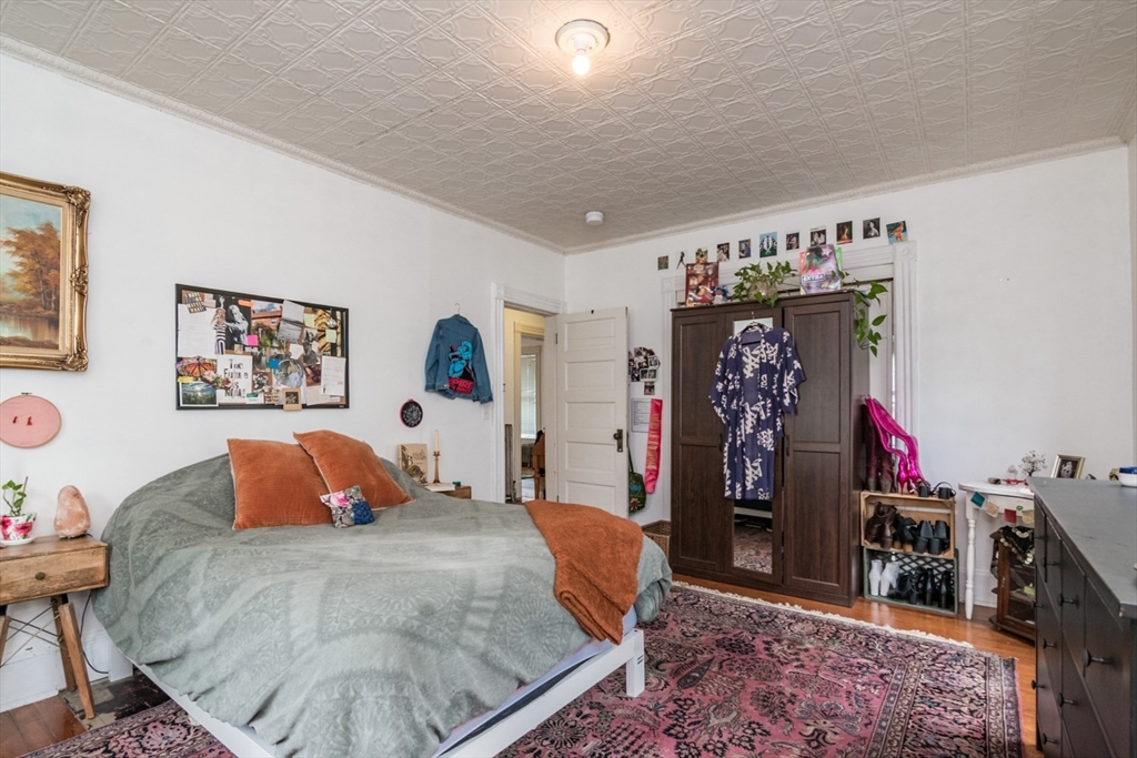 25 Morgan Street Holyoke, MA 01040 - Photo 14 of 41 a bed room with a bed and a walk in closet