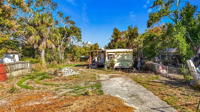 an aerial view of residential house with outdoor space and trees all around