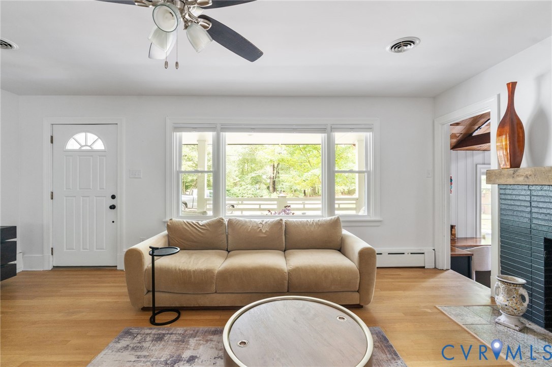 7944 Cherokee Road Richmond, VA 23225 - Photo 10 of 50 a living room with furniture a fireplace and a large window