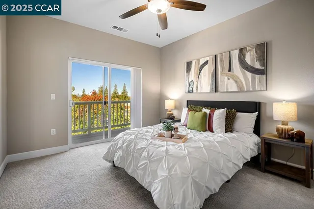 a large bed sitting in a bedroom next to a window