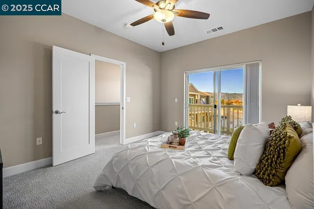 a bedroom with a large bed and a window