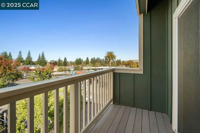 a view of a balcony with wooden fence and floor