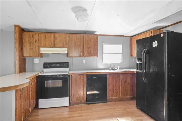 a kitchen with stainless steel appliances granite countertop a refrigerator and a sink