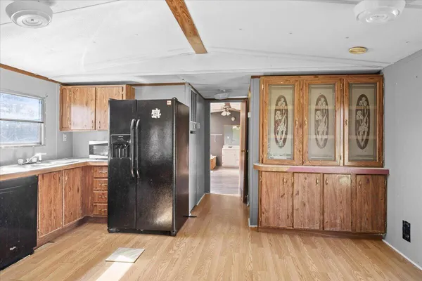 a view of a room with wooden floor and a ceiling fan