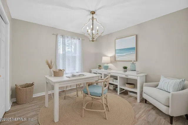a view of a kitchen with a dishwasher a kitchen island hardwood floor and a window
