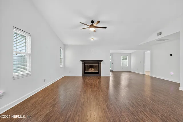 a kitchen with cabinets stainless steel appliances a sink and a window