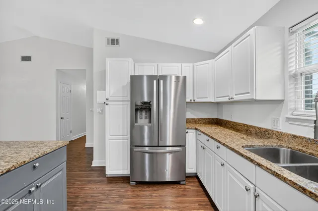 a view of a big room with wooden floor and a ceiling fan