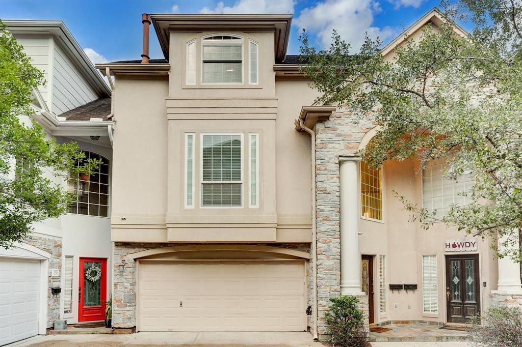 a front view of a house with garage