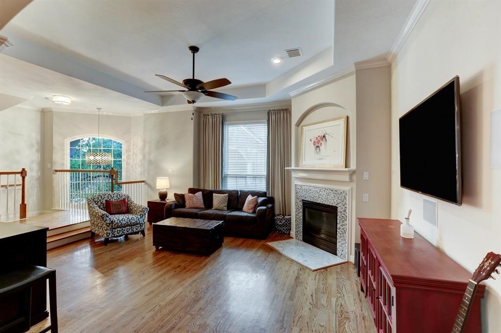 248 Westcott Street Houston, TX 77007 - Photo 11 of 32 a living room with fireplace furniture and a flat screen tv