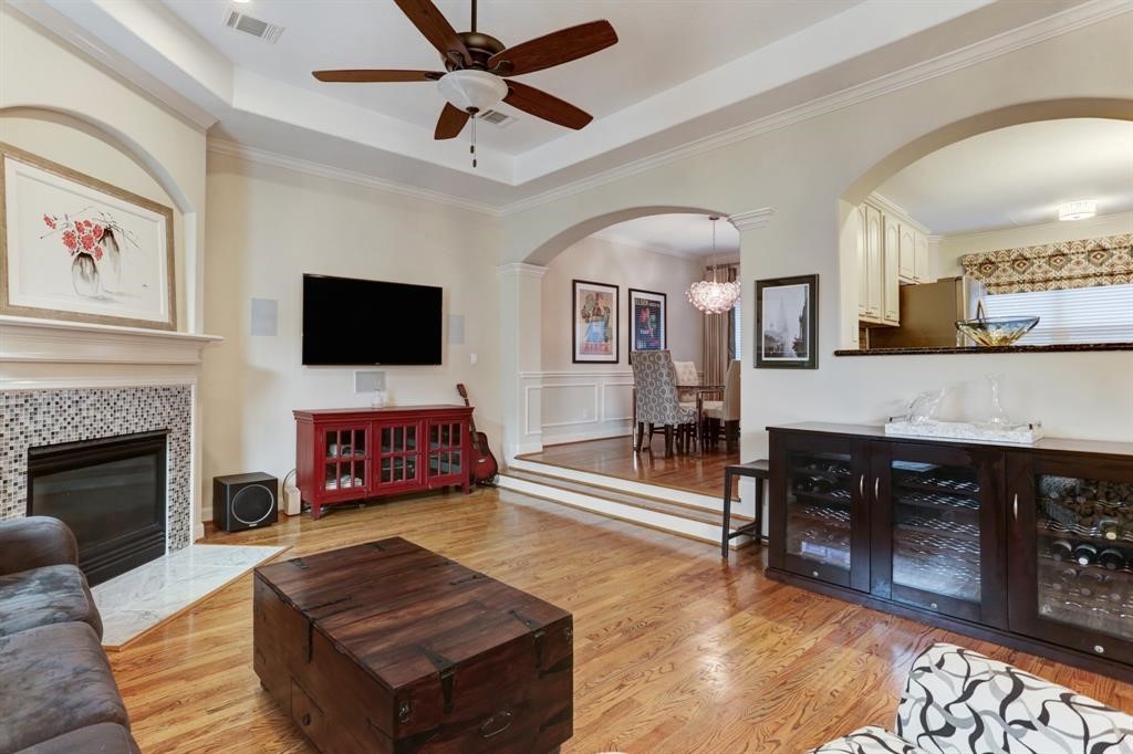 248 Westcott Street Houston, TX 77007 - Photo 12 of 32 a living room with furniture a fireplace and a flat screen tv