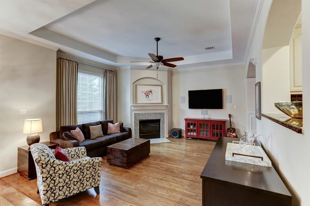 248 Westcott Street Houston, TX 77007 - Photo 14 of 32 a living room with furniture a fireplace and a flat screen tv