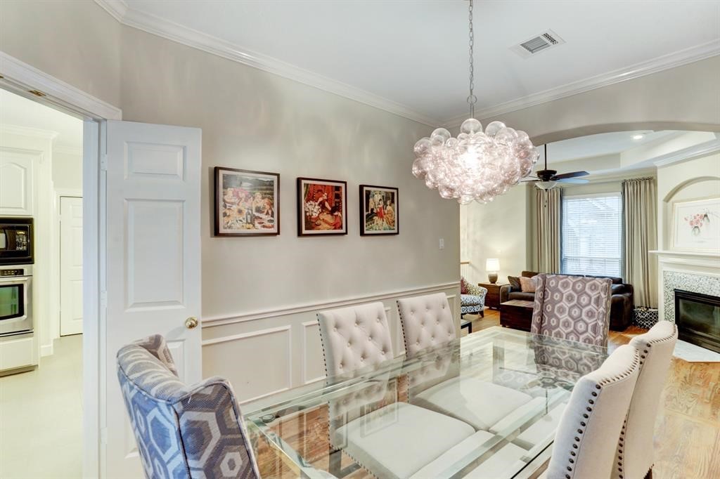 248 Westcott Street Houston, TX 77007 - Photo 16 of 32 a living room with furniture and a chandelier
