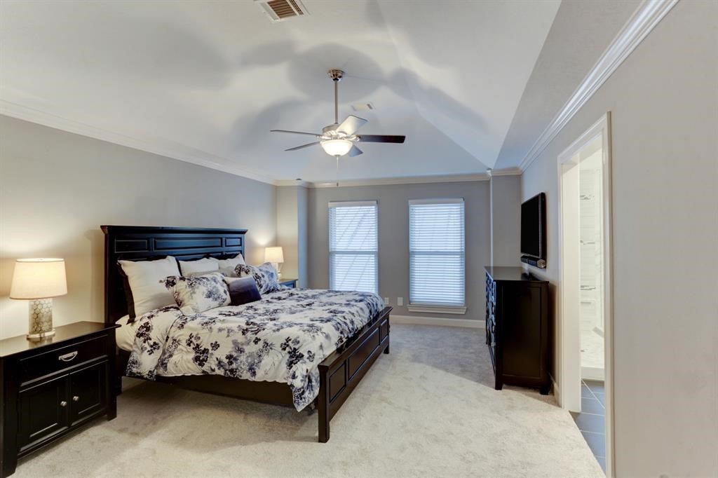 248 Westcott Street Houston, TX 77007 - Photo 27 of 32 a bedroom with a bed and a chandelier