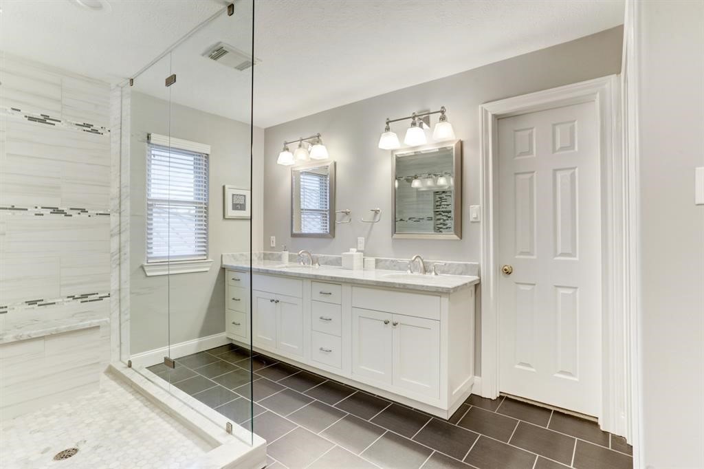 248 Westcott Street Houston, TX 77007 - Photo 30 of 32 a spacious bathroom with a granite countertop sink mirror and a