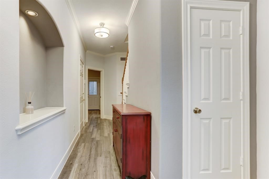 248 Westcott Street Houston, TX 77007 - Photo 7 of 32 a view of a hallway with wooden floor and staircase