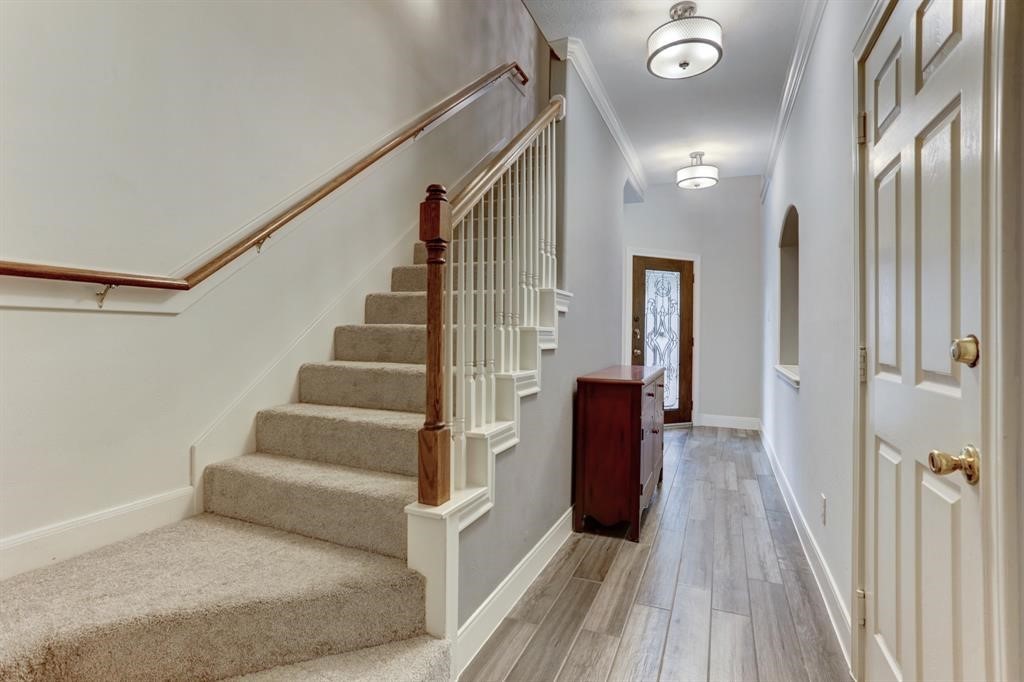 248 Westcott Street Houston, TX 77007 - Photo 8 of 32 a view of a hallway with wooden floor and staircase