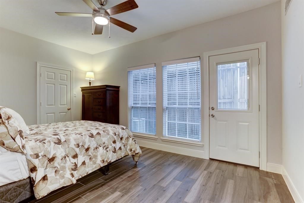 248 Westcott Street Houston, TX 77007 - Photo 9 of 32 a bedroom with a bed and wooden floor