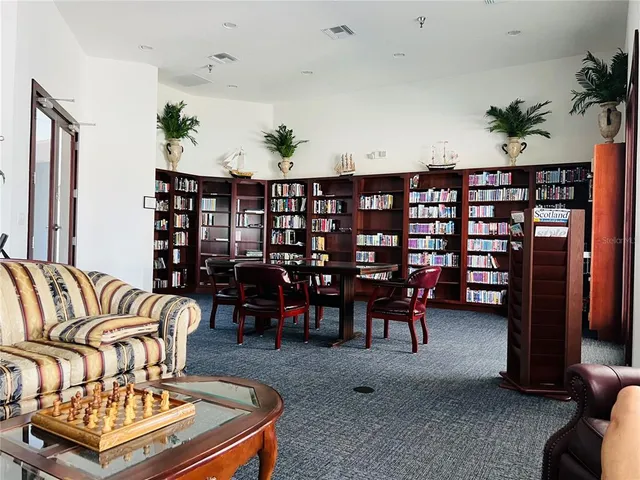 a living room with furniture a couch and potted plant