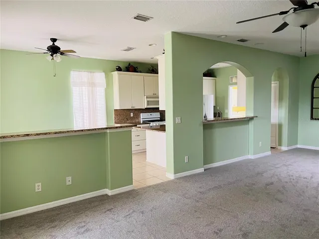 a view of a kitchen with a fridge and a window