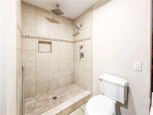 a bathroom with a shower and toilet