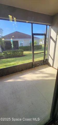 a view of an empty room with a floor to ceiling window and an outdoor view