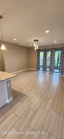 a view of a kitchen with white cabinets