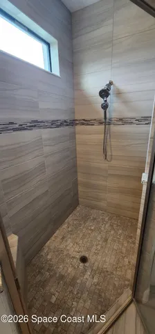 a large kitchen with stainless steel appliances a large counter top a stove and cabinets